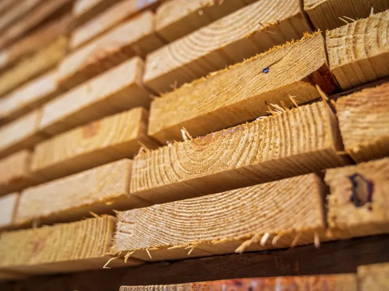 Neatly stacked lumber boards outdoors