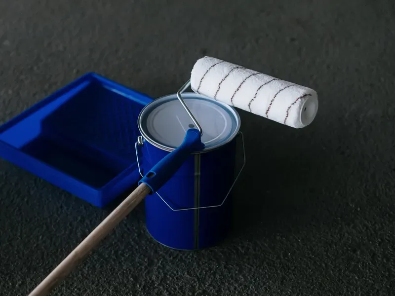 Paint can and roller on a tray, ready for a painting project