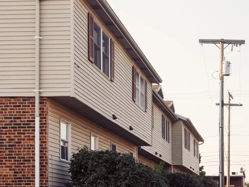 Row of suburban houses with brick and siding exteriors