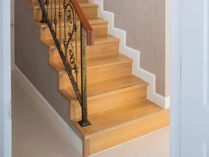 Wooden staircase with railing inside a home