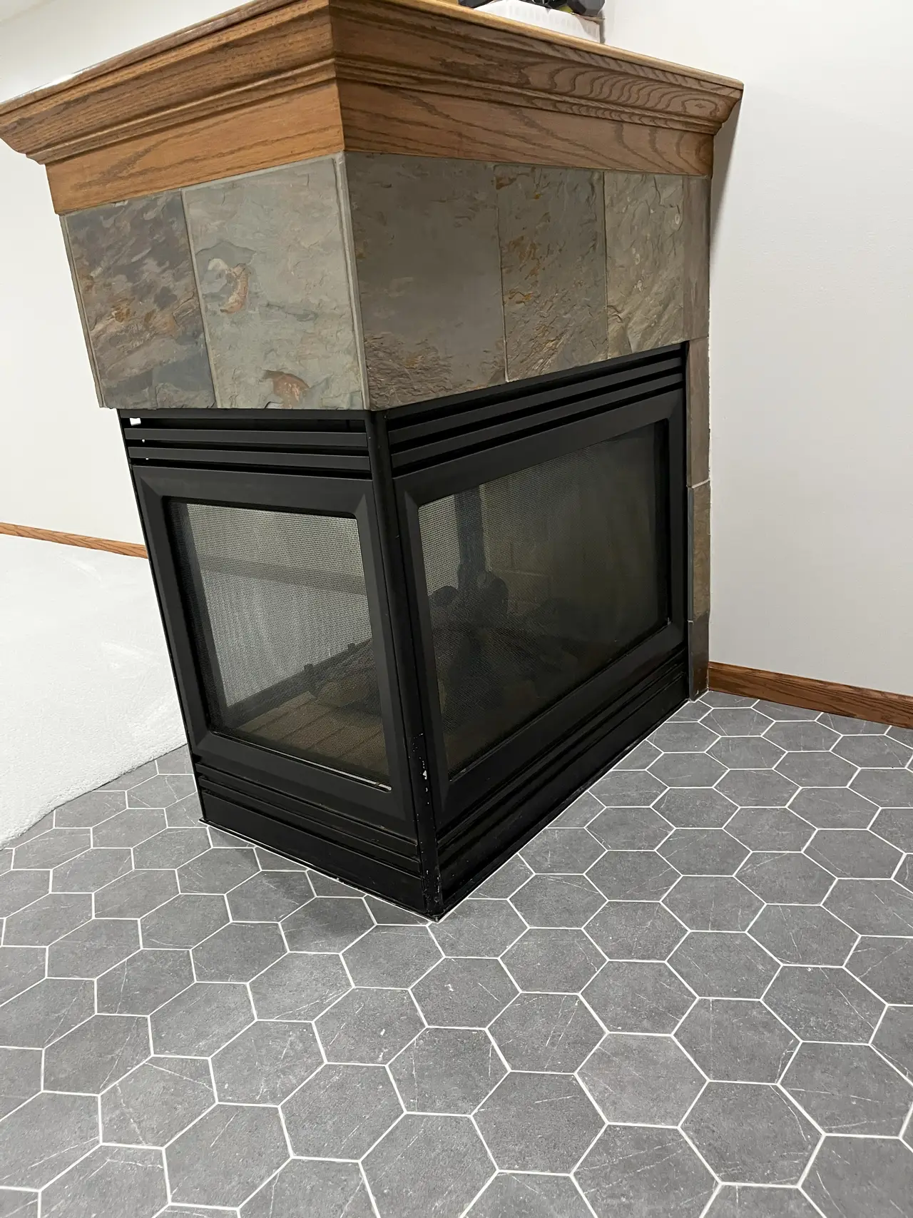 Hexagonal tile flooring near a fireplace